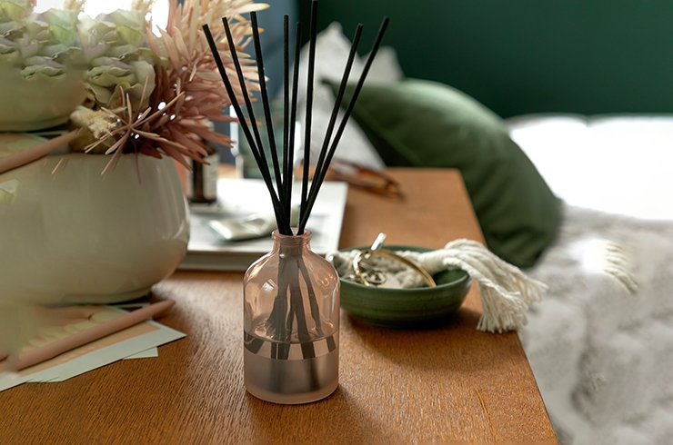 Scented reed diffuser in a glass bottle.